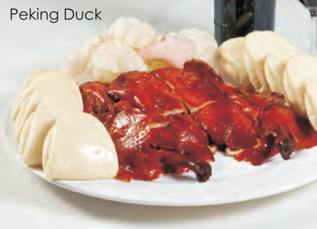 Duck roasted to perfection served with Asian flat bread, green onion, and sweet duck
					sauce
